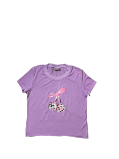 Purple t-shirt with a pink bow and black and white polka dot design on a white background
