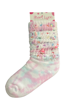Colorful tie-dye sock with ruffles and text on a white background