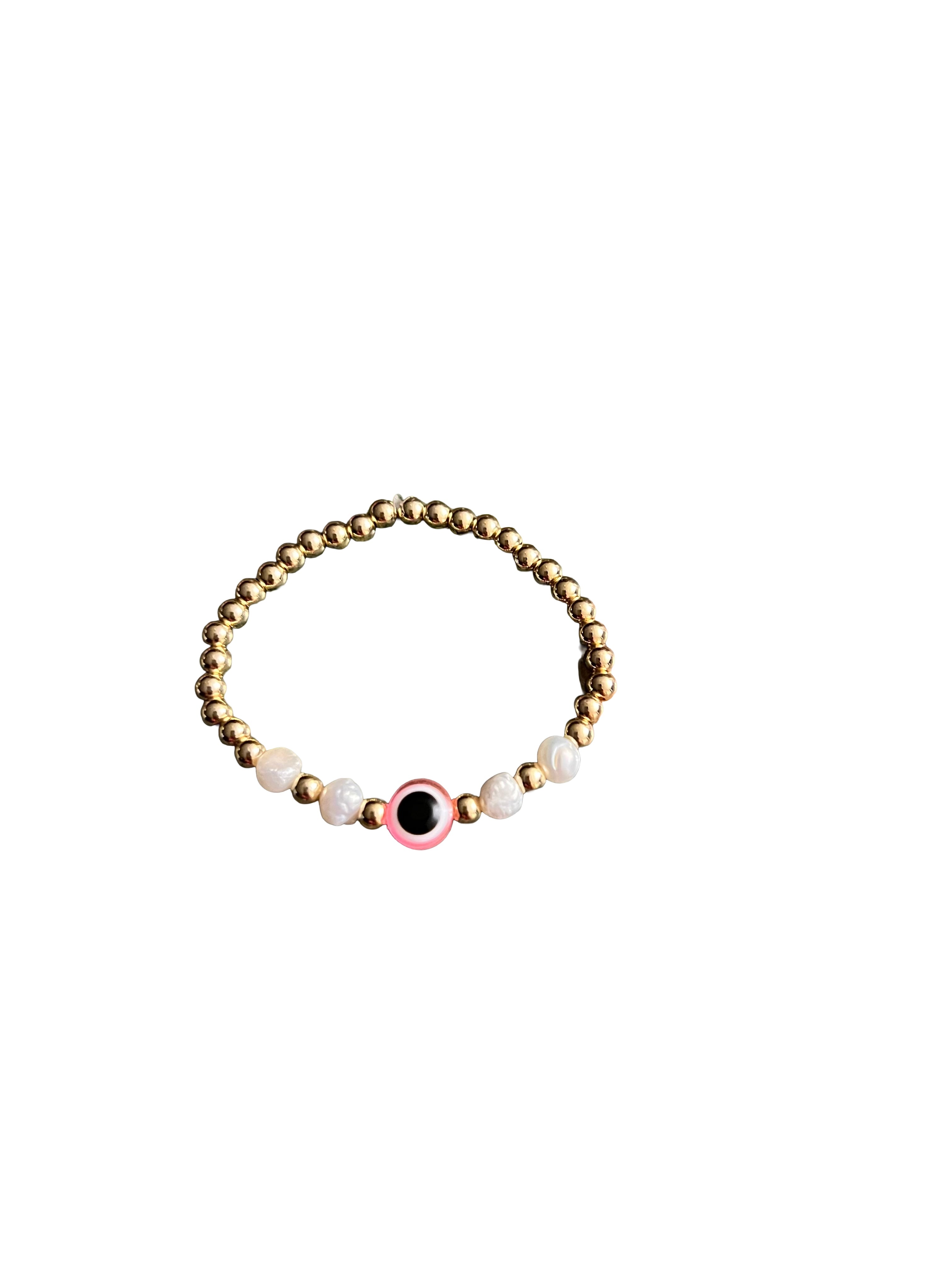 Bracelet with gold, black, and pearl beads on a white background